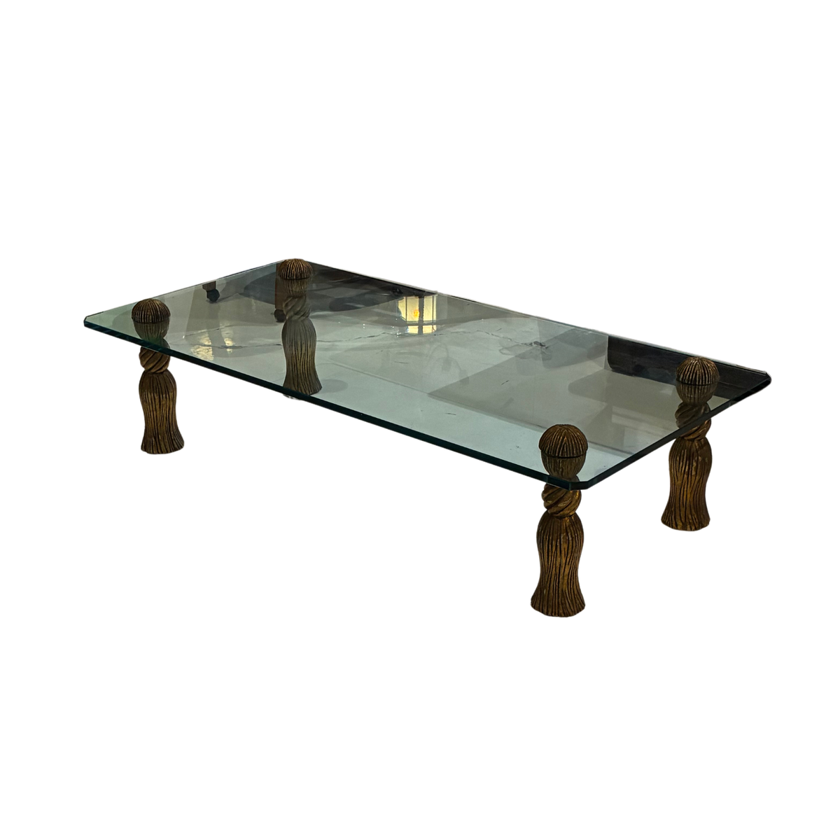 Mid-Century Modern Coffee Table in the manner of Phyllis Morris, featuring a rectangular glass top supported by four ornate gilt-finished tassel-shaped legs.