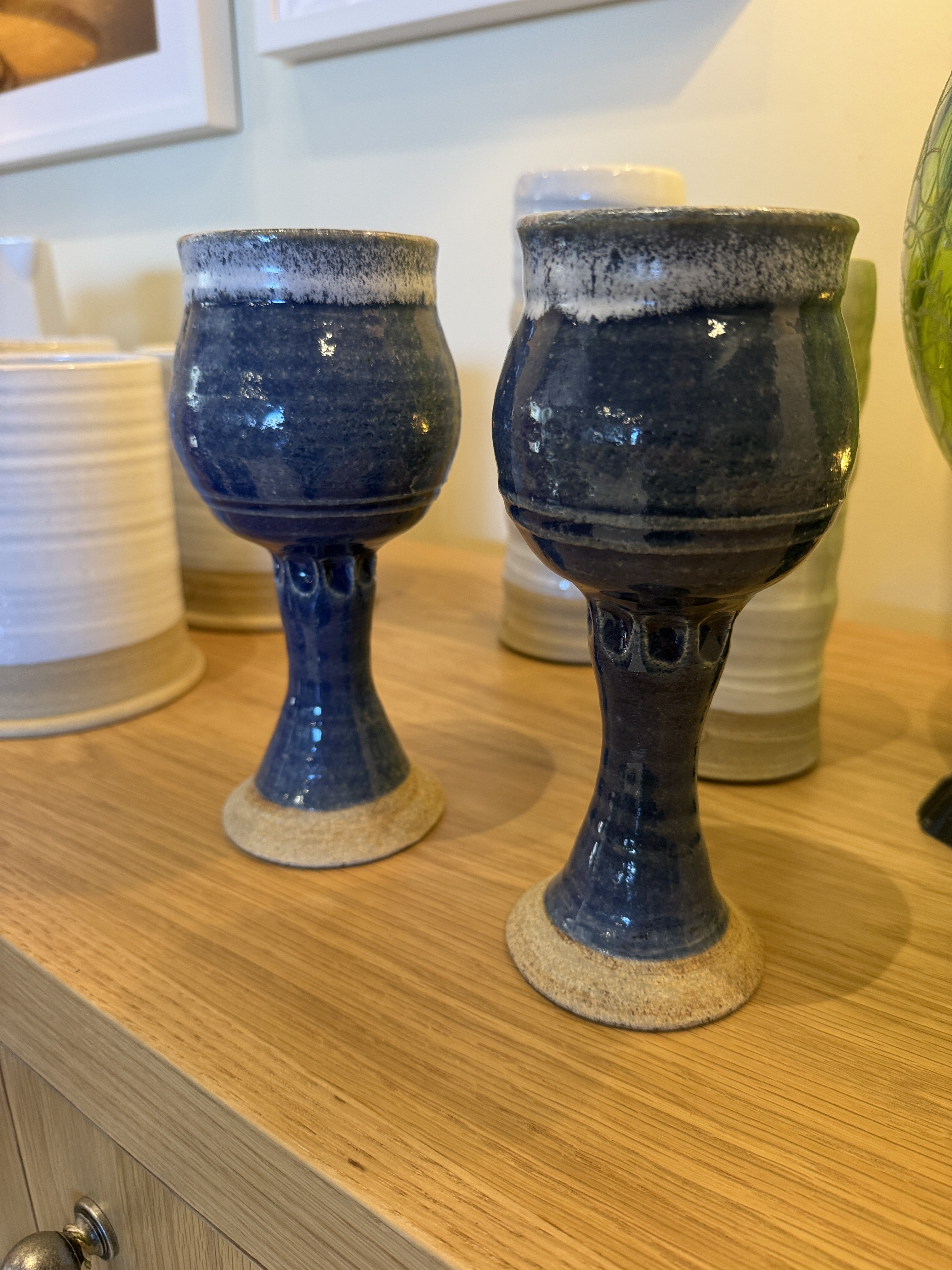 Vintage Ceramic Wine Goblet. Authentic 1994 wheel-thrown stoneware creation by the American studio potter Jim Clark, featuring a deep blue/cobalt glaze with a contrasting white frothy drip glaze along the rim and an unglazed, raw stoneware base.